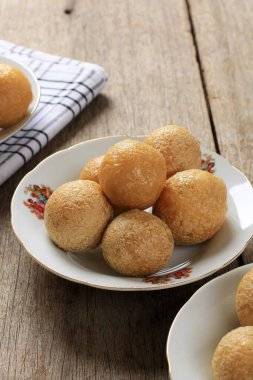 Close Up Tahu Bulat (Round Tofu), Indonesian Favorite Dish, Deep Fried and Seasoned with Seasoning Powder. Served in Bamboo Plate (pincuk)