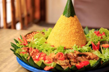 Yellow Rice Tumpeng, Rice with Cone Shape, Made from Rice and Turmeric, Accompanied with Various Side Dish Such As Fried Chicken, Egg, Tempeh, Tofu, and Chilli Paste
