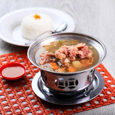 Sop Iga or Sop Buntut, Beef Clear Soup with Indonesian Traditional Recipe. Made from Beef Oxtail or Beef Ribs. Served on Stainless Bowl Make it Always Warm