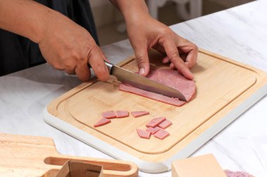 Asian Chef Female Hand Sliced Smoked Beef into Small Pieces. Cooking Process in the Kitchen 