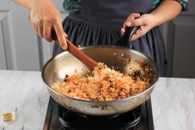 Cooking Process : Making Korean Kimchi Fried Rice or Bokkeumbap using Stainless Wok Pan, Mix Stir Fry Kimchi with White Rice (Bap). 