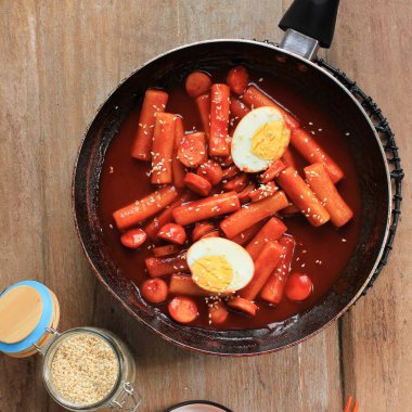 Top View Topokki or Tteokbokki is Stir-fried Rice Cake with Vegetables and Fish Cake in Spicy Sauce Top with Sesame Seed, Famous and Popular Korean Street Food