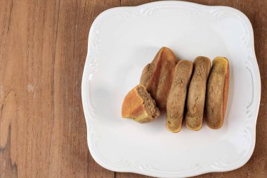 Pukis is a Popular Traditional Snack in Indonesia. This Snack is One Varian of Jajanan Pasar. Copy Space on Wooden Background