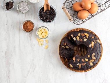 Chocolate Brownies Black Sticky Rice Flour (Brownies Ketan Hitam) Decorated with Almond Slice on Dark Background, Copy Space on White Background
