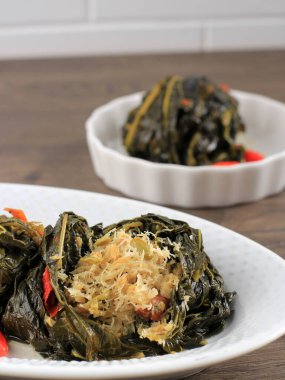 Selected Focus Buntil is Traditional Indonesian Food Made from Papaya/Cassava Leaves Stuffed with Grated Coconut, Petai Cina,  and Anchovy Fish. Popular in Javanese and Sundanese Cuisine 