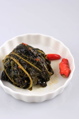 Buntil is Traditional Indonesian Food Made from Papaya/Cassava Leaves Stuffed with Grated Coconut, Petai Cina,  and Anchovy Fish. Popular in Javanese and Sundanese Cuisine, Copy Space Isolated