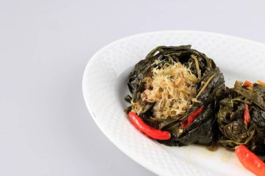 Buntil is Traditional Indonesian Food Made from Papaya/Cassava Leaves Stuffed with Grated Coconut, Petai Cina,  and Anchovy Fish. Popular in Javanese and Sundanese Cuisine, Copy Space 