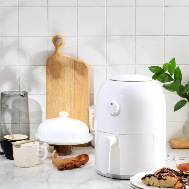 Cooking Process Using White Mini Air Fryer in the Kitchen. Cooking with Air Fryer is Healthy Frying Style with No Oil or Less Oil