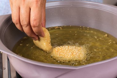 Close Up COoking Process, Frying Fried Bread (Odading) in Hot Oil
