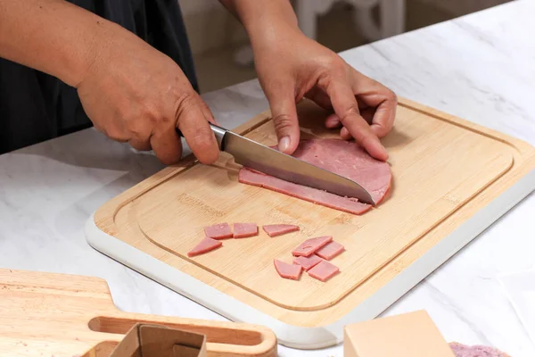 Asian Chef Female Hand Sliced Smoked Beef into Small Pieces. Cooking Process in the Kitchen