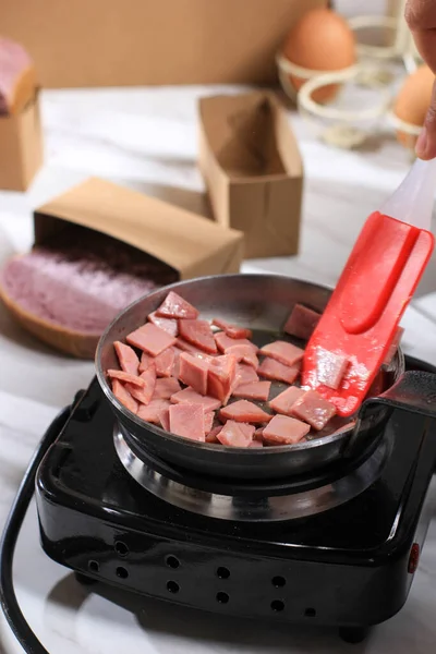 Stir Fry Cooking Process Cut Diced Salami (Thin Slice Smoked Beef) with Butter in the Kitchen.