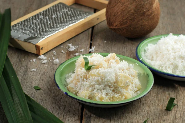 South East Asian Style (Indonesian or Thai) Steamed Cassava with Grated Coconut on Enamel Plate. Popular in Indonesia Called Sentiling
