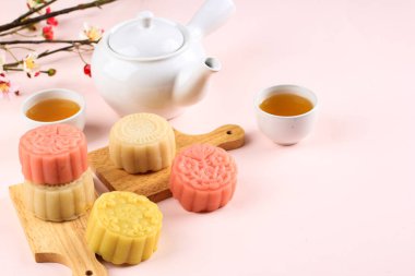 Selected Focus Concept Various Mooncake, Traditional and Colorful Snow Skin Moon Cake, Dessert for Mid-Autumn Festival on Pink Background, Close up, Lifestyle.