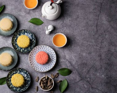 Colorful Snow Skin Moon Cake, Sweet Snowy Mooncake, Traditional Savory Dessert for Mid-Autumn Festival on Stone Background, Selected Focus, Copy Space