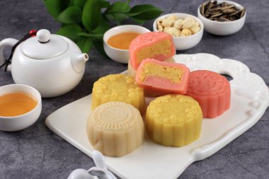 Colorful Snow Skin Moon Cake, Sweet Snowy Mooncake, Traditional Savory Dessert for Mid-Autumn Festival on Stone Background, Selected Focus