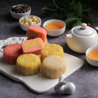 Colorful Snow Skin Moon Cake, Sweet Snowy Mooncake, Traditional Savory Dessert for Mid-Autumn Festival on Stone Background, Close up, Lifestyle. Selected Focus 