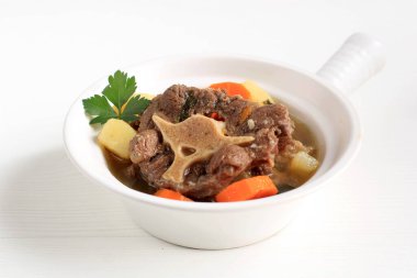 Indonesian Oxtail Soup or Sop Buntut on White Bowl, Isolated
