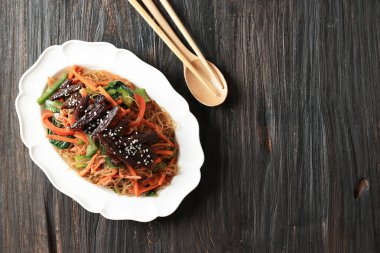 Top View Beef Bulgogi Japchae, Korean Stir Fry Vermicelli with Beef Bulgogi