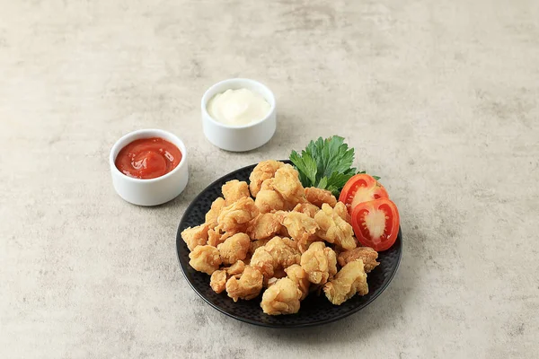 Chicken Popcorn, Small Slices Chicken with Crispy Flour Coating and Deep Fried. Served with Manonaise and Spicy Chilli Sauce. Copy Space for Text