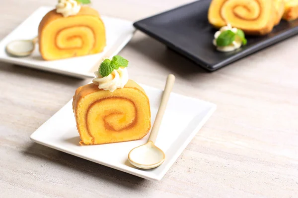 Slice Pineapple Roll Cake or Bolu Gulung Nanas, Thin Cake Rolled with PIneapple Jam with Cheese Frosting on Top.