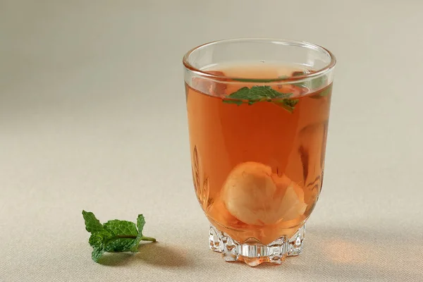 Lychee Tea, Sweet Tea with Canned Litchi and Mint Leaf. Copy Space for Text