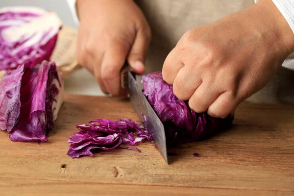 stock image Female Slicing Purple Cabbage on Wooden Chopping Board, Close Up