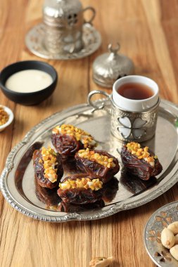 Stuffed Dates Turkish Style Date with Pistachio, Served with Tea  clipart