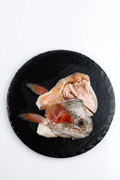 Frozen Salmon Fish Head Ready to Cook, Top View on SLate Plate