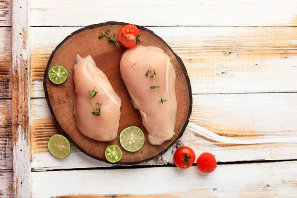 Stock image Top View Chicken Breat Fillet on Wooden Chopping Board, Copy Space for Text on White Wooden Table. Concept Protein Source