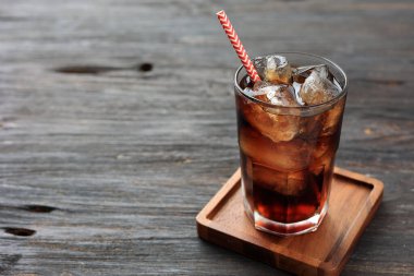 A Glass of Cola with Ice on Wooden Table, Copy Space for Text  clipart