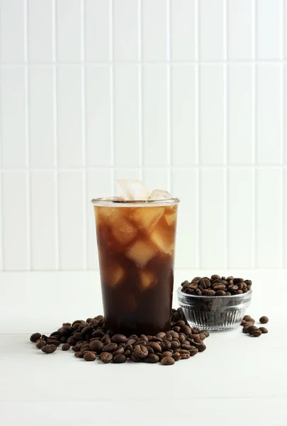Cold Ice Coffee with Coffee Beans on White Background, Copy Space for Text