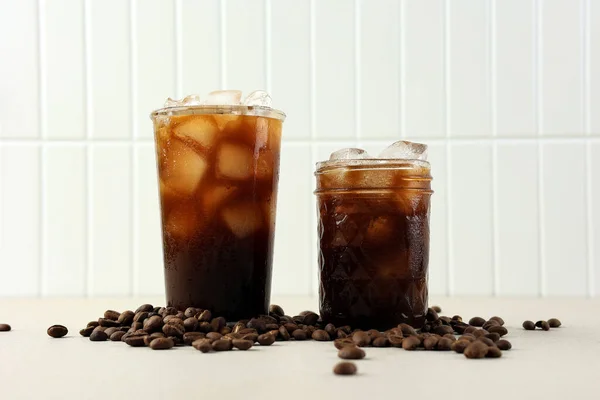 Two Glass Iced Black Coffee with Cofee Bean on White Background, Fresh Summer Drink