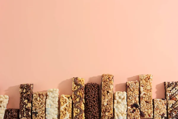 Various Energy Bar or Granola Bar, Top View on Pastel Background with Copy Space for Text