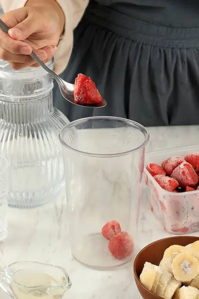 Process Making Berry Smoothies, Put Frozen Strawberry and Frozen Banana to the Blending Hand  Bowl