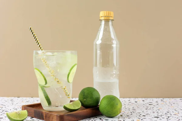 Cold Lime Soda in the Glass with Golden Paper Straw