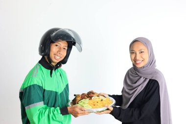 Muslim Woman Ordering Nasi Kebuli using Online Apps Delivery. Concept  for Parcel or Hampers Lebaran Go Food clipart