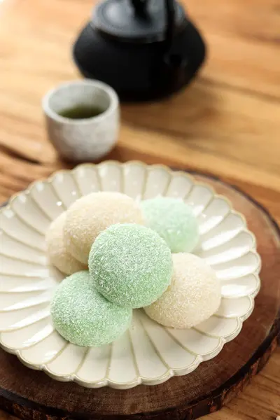 stock image Japanese Mochi with Dry Coconut Coating, Served with Matcha Tea 