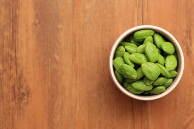 Raw Peeled Petai or Pete Parkia speciosa. Known as Stinky Bean or Bitter Bean, Top View with Copy Space for Text  clipart