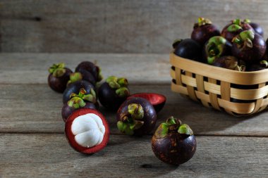 Fresh Mangosteen or Known as The Queen of Fruits on Rustic Wooden Table, Asia Fruits Concept clipart