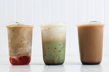 Three Various Iced Drink Coffee, Strawberry Espresso Latte, Green Tea Matcha Milk Latte, and Kopi Susu Gula Aren  clipart