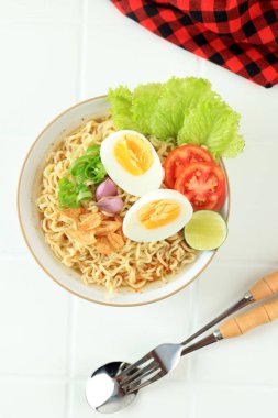 Top View Mie Kuah Telur or Instant Noodle Soup Served on White Bowl, Copy Space for Text  clipart