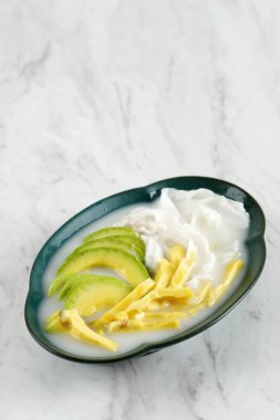 Es Teler or Es Teller, Popular Indonesian Fruit Cocktail Consist of Avocado, Young coconut, Jackfruit, Served with Simple Syrup and Condensed Milk