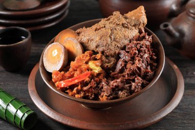 Close Up Gudeg Komplit. Signature and Legendary Dish from Yogyakarta Indonesia. Jack Fruit Stew Accompanied with Spicy Stew of Cattle Skin Crackers and Brown Eggs clipart