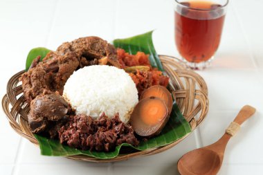 Nasi Gudeg,  Typical Food from Yogyakarta, Indonesia. Rice with Jackfruit Stew Cooked with Coconut Milk. Served with Hot Tea clipart