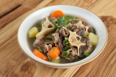 Endonezya Öküz Kuyruğu Çorbası ya da Sop Buntut Beyaz Kâse 'de Tahta Masa 