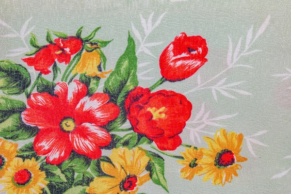 Composition of bright flowers on a coarse linen cotton fabric. Ukrainian ethnic ornament.