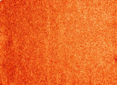 Örgü kumaşlı arka plan. Örgü örüyorum. Renkli kırmızı-turuncu örgü desenli. Kırmızı iplik.