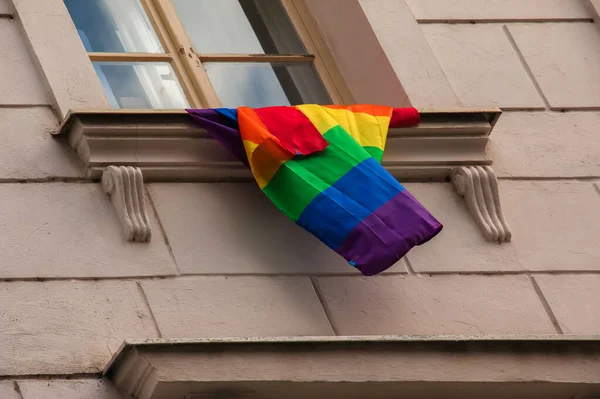 Pride of the LGBT rainbow flag in the city of Bratislava. View of the window of a building with a rainbow flag.