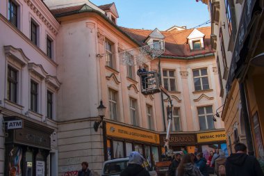 Bratislava, Slovakia - 01.07.2023: Municipal services of Bratislava remove Christmas illumination in old Bratislava