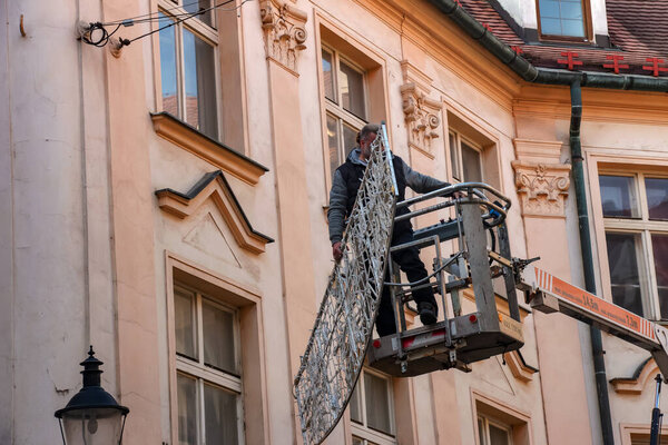 Bratislava, Slovakia - 01.07.2023: Municipal services of Bratislava remove Christmas illumination in old Bratislava